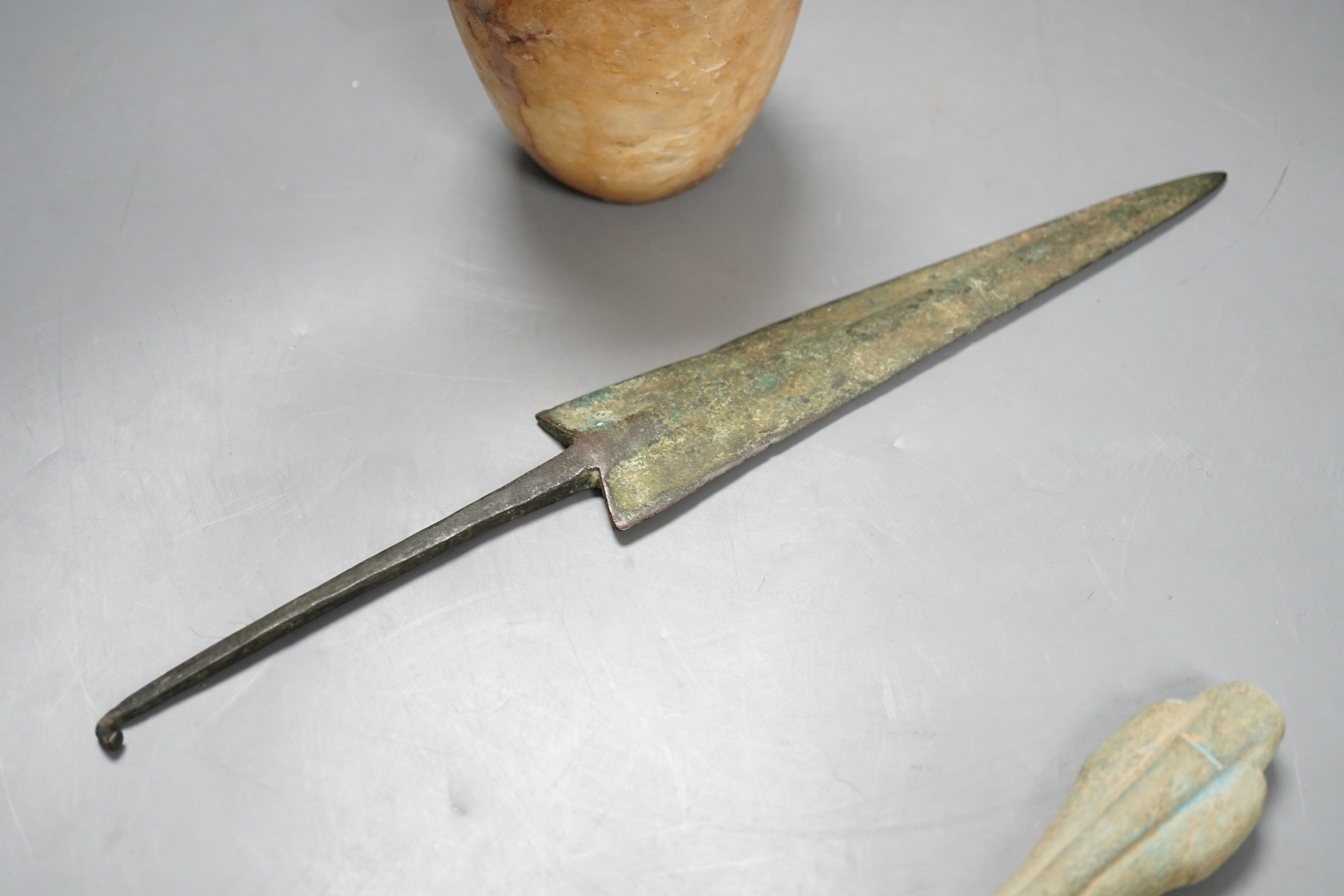 Antiquities to include a Luristan bronze spear head, an Egyptian ushabti (af) and an alabaster jar, spear head 30.5cm long